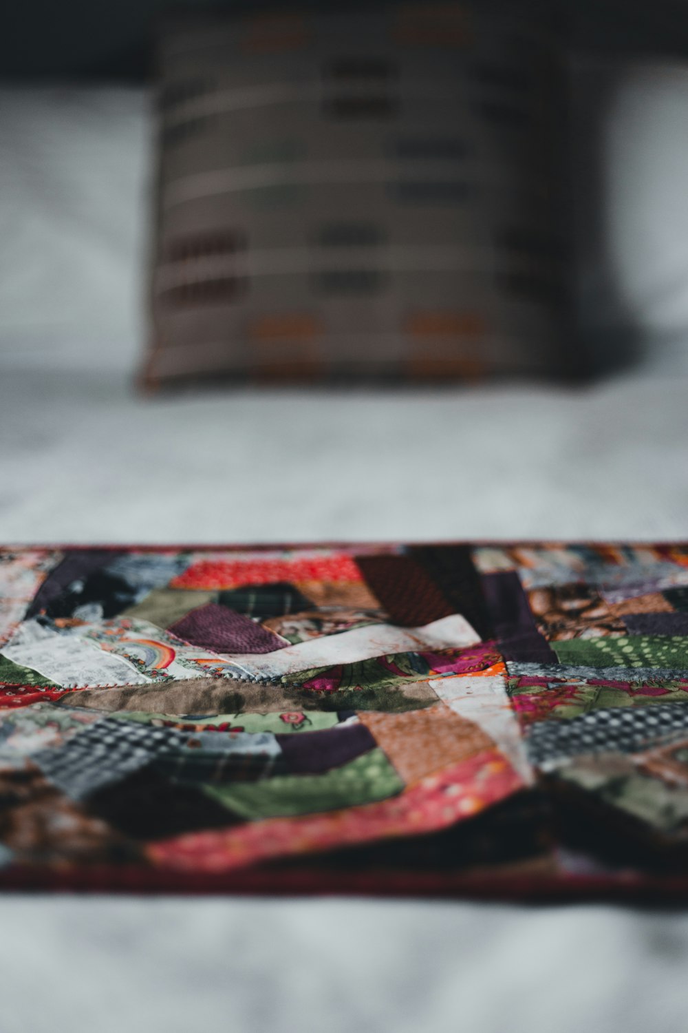 a close up of a patchwork quilt on a bed