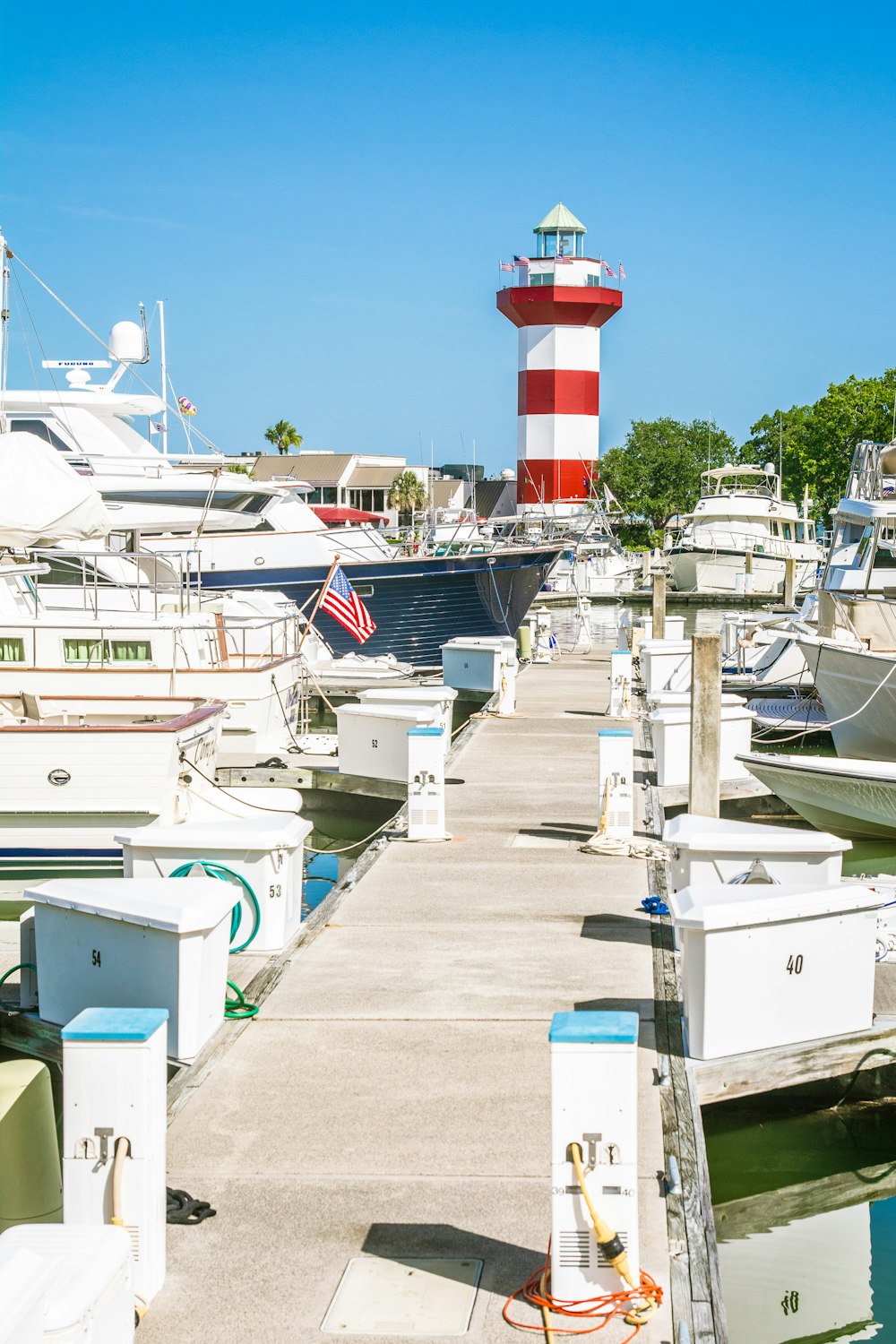 a red and white light house next to a dock