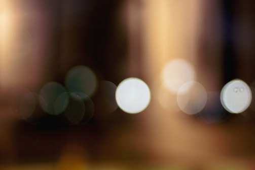 Soft, out-of-focus lights create a dreamy and abstract effect, with circular bokeh patterns in various sizes. The colors blend gently, enhancing the overall softness.