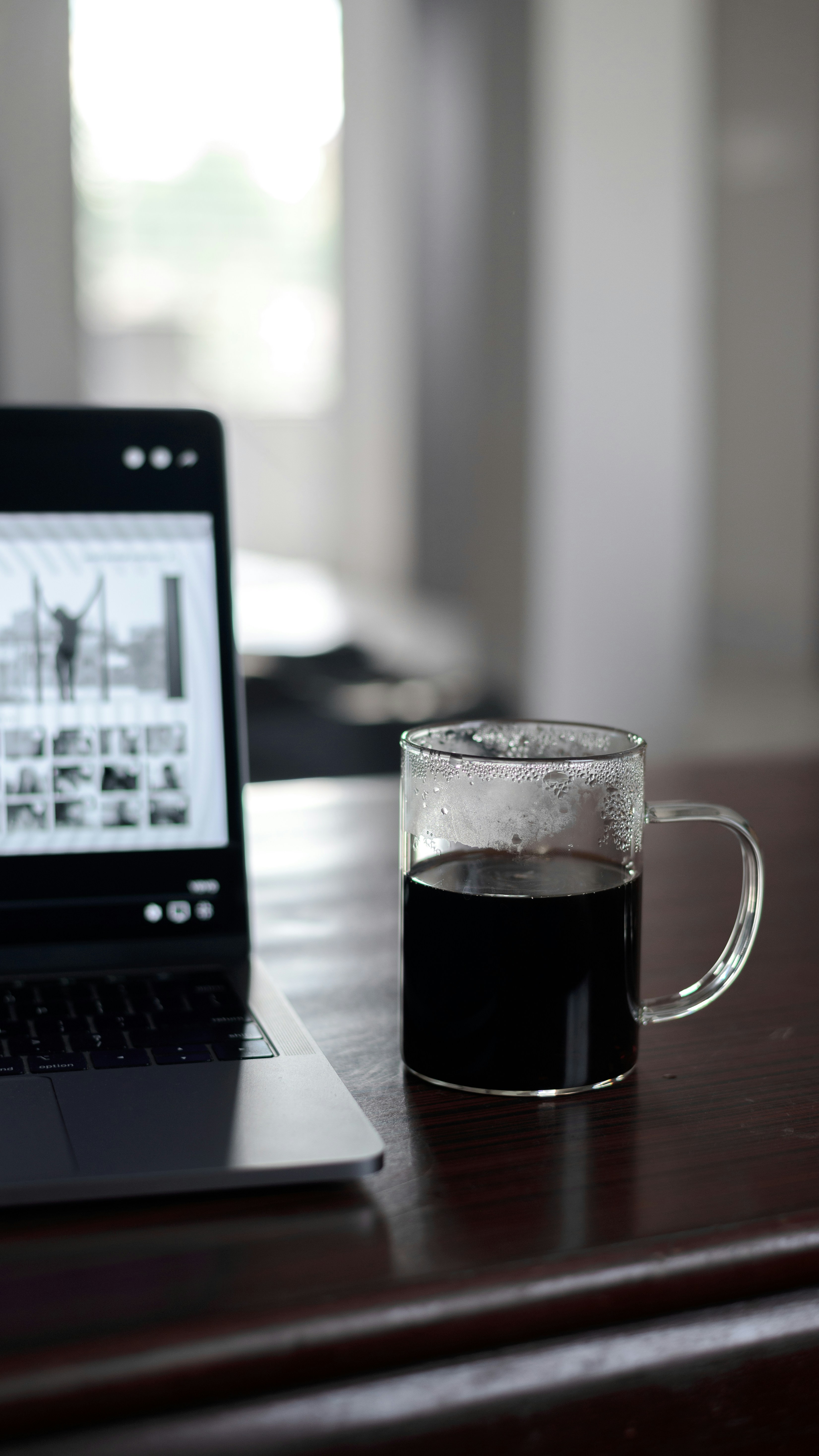 a laptop computer sitting on top of a wooden desk