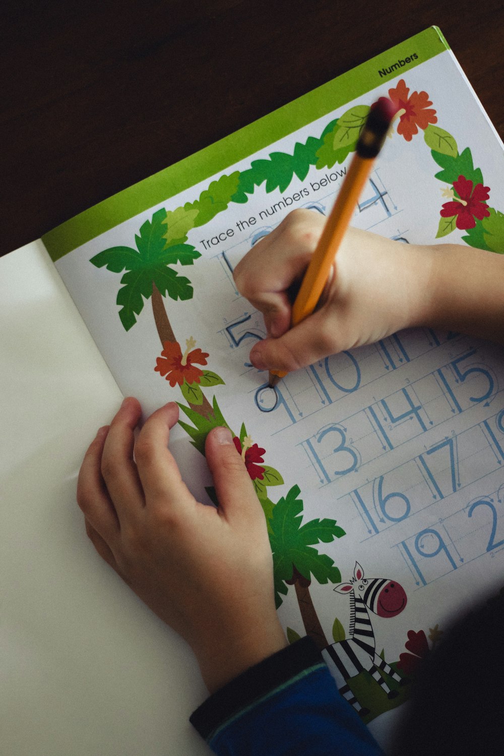 a child is writing on a sheet of paper