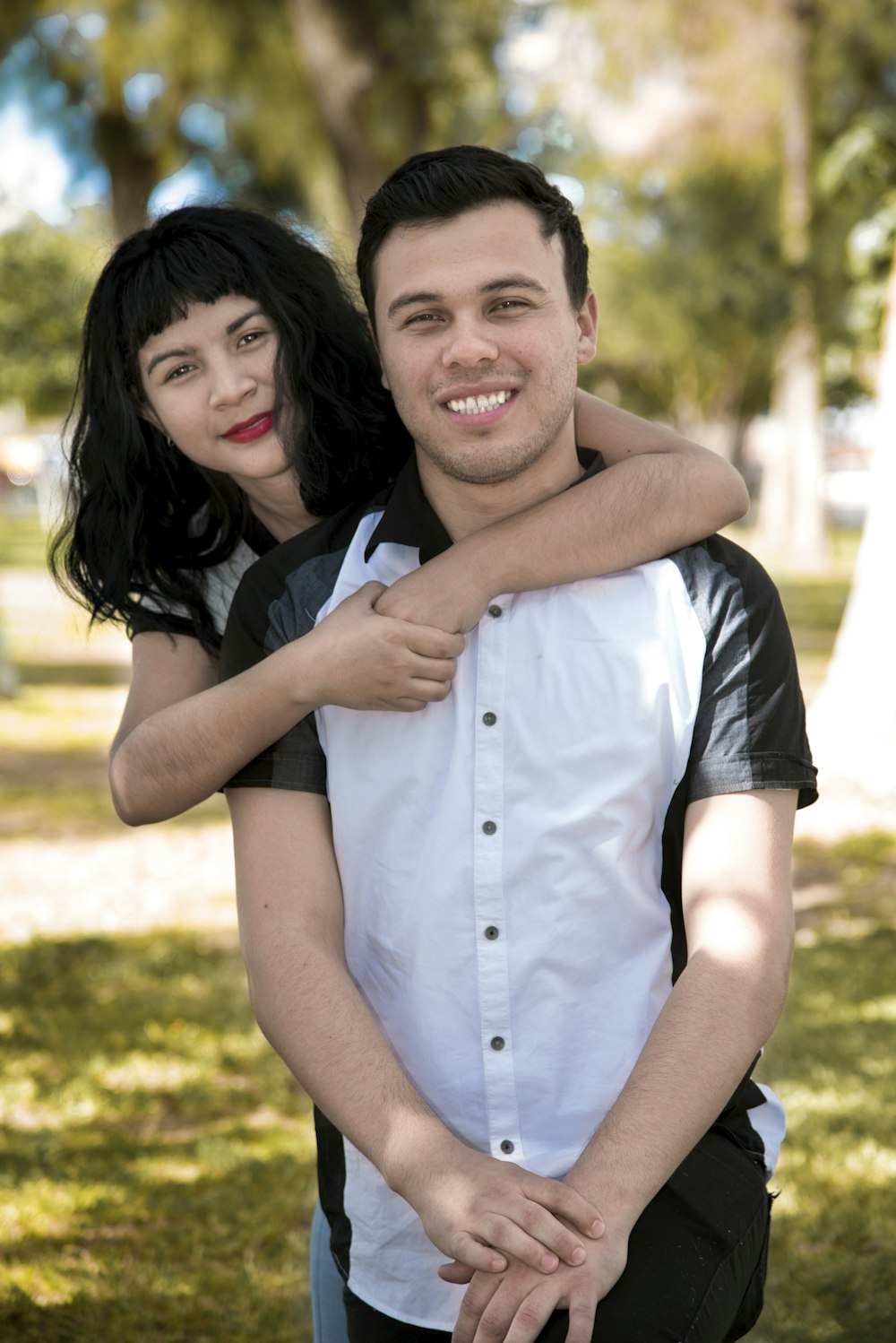 a man holding a woman in a park