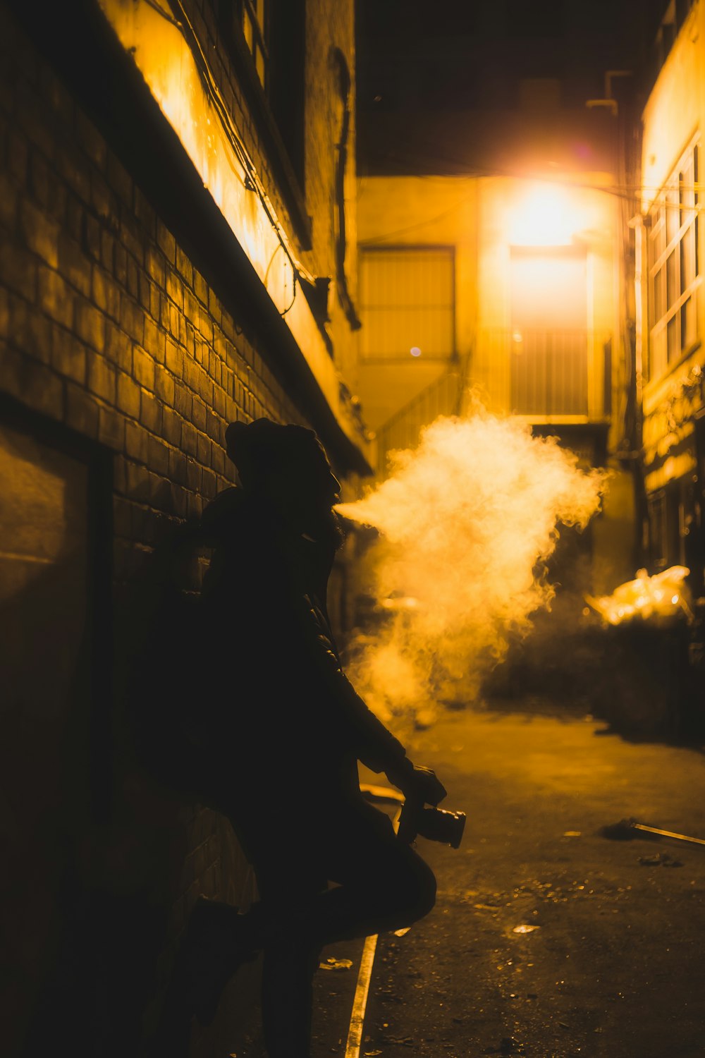 a person sitting on a ledge with a fire extinguisher