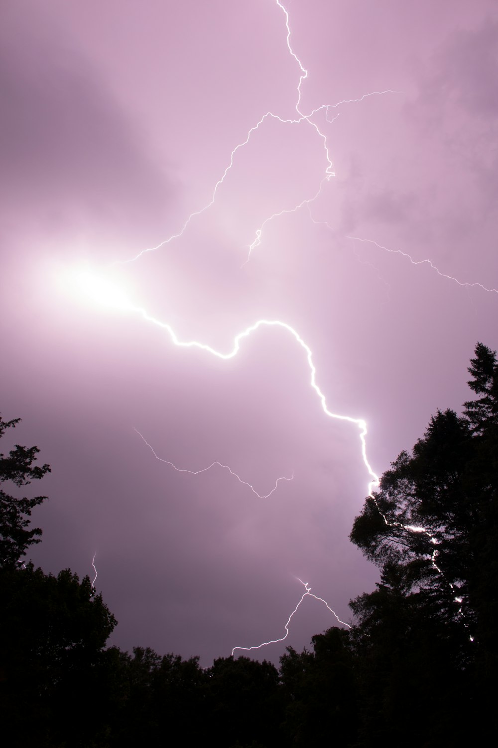 a purple sky with a lightning bolt in the middle of it