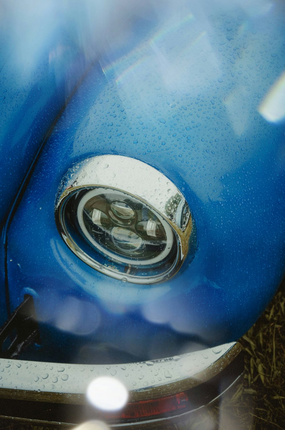 a close up of the front end of a blue car