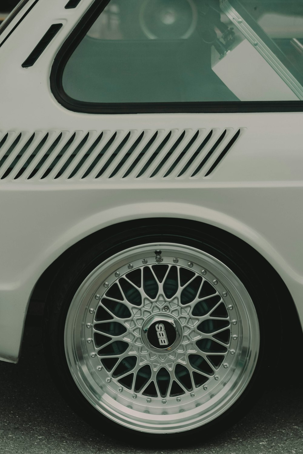 a close up of a white car with chrome rims