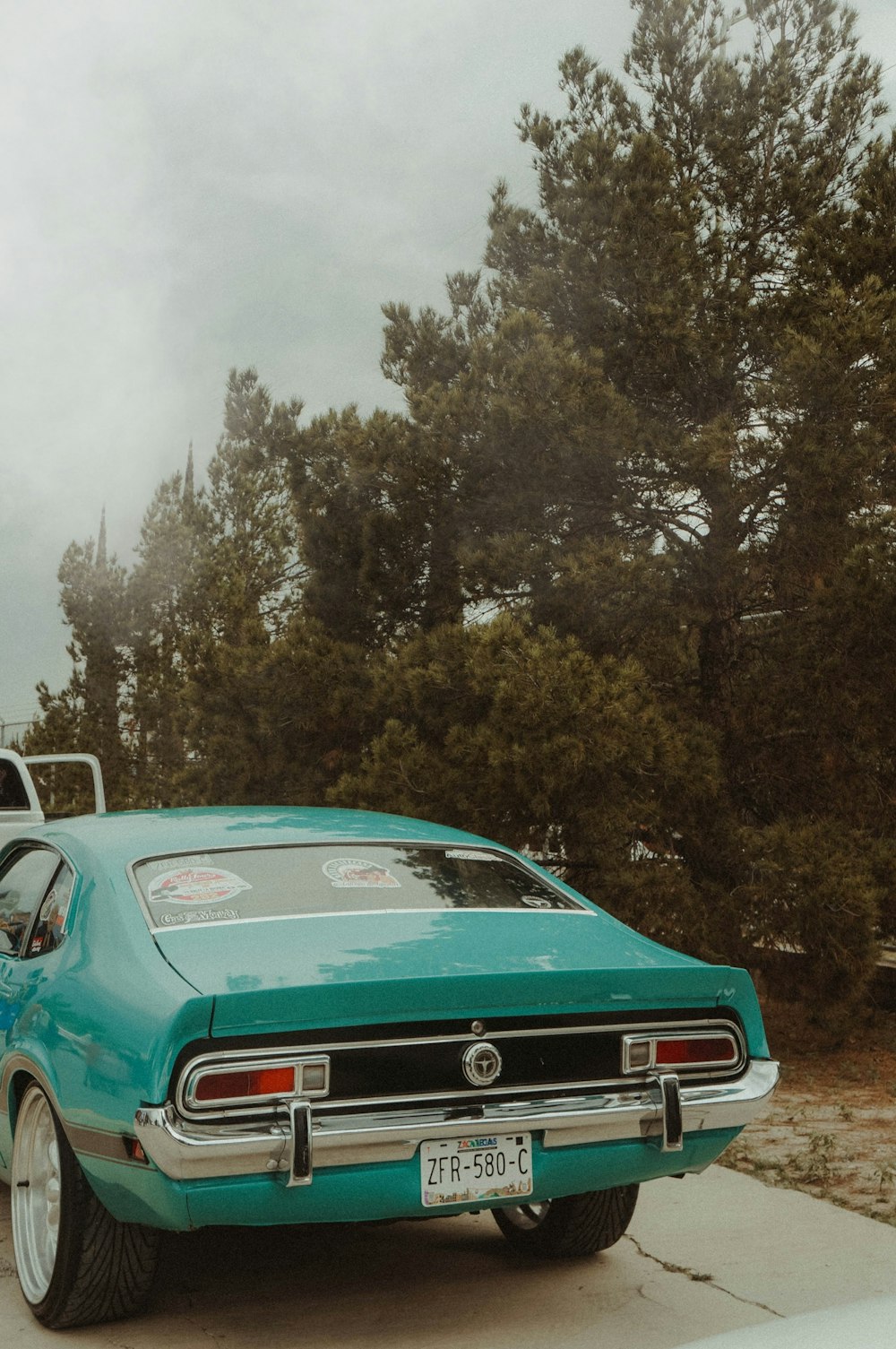 a green car parked on the side of the road