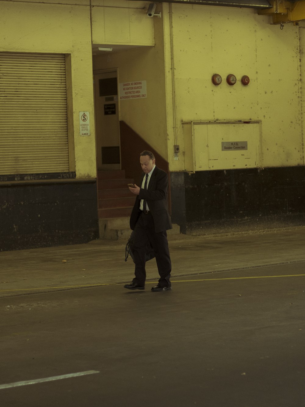 a man in a suit walking down a street