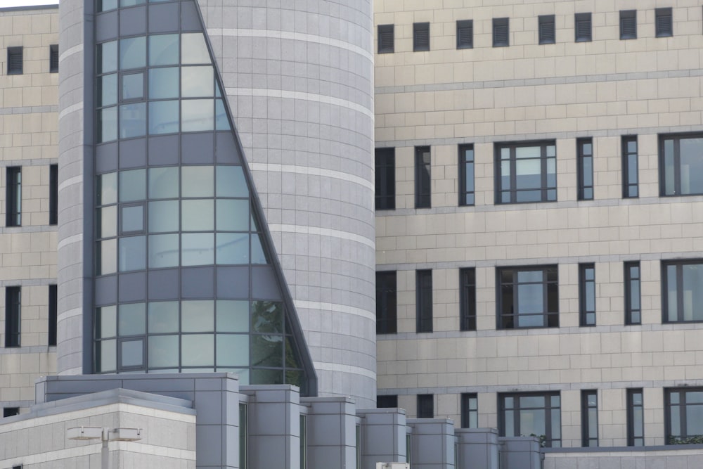 a tall building with many windows next to a parking meter