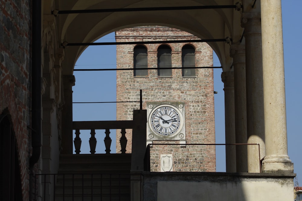 a clock on the side of a brick building