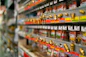 Shelves stocked with different types of screws, nails, and fasteners in a hardware store.