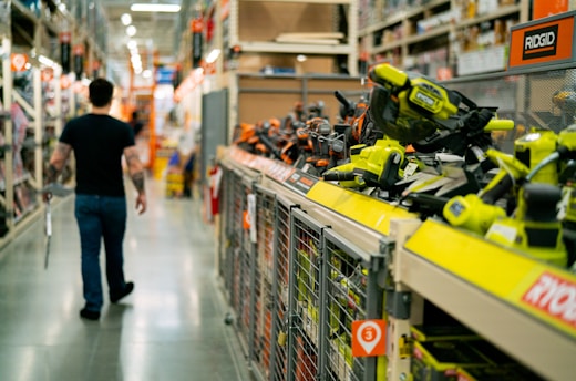 a man is walking down a store aisle