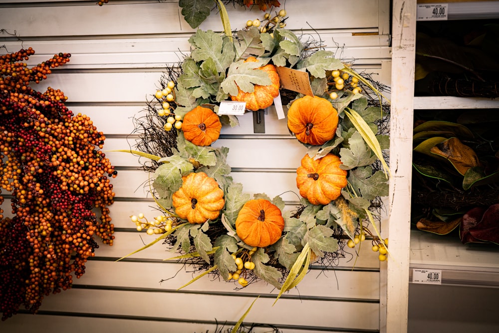 a wreath of pumpkins and gourds on a wall