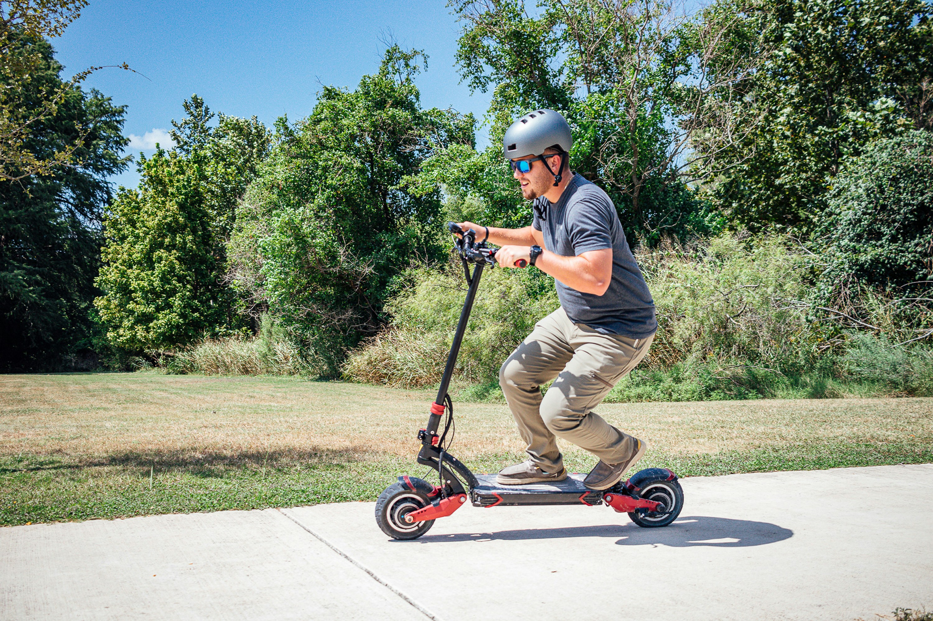 a man riding a scooter on a sidewalk