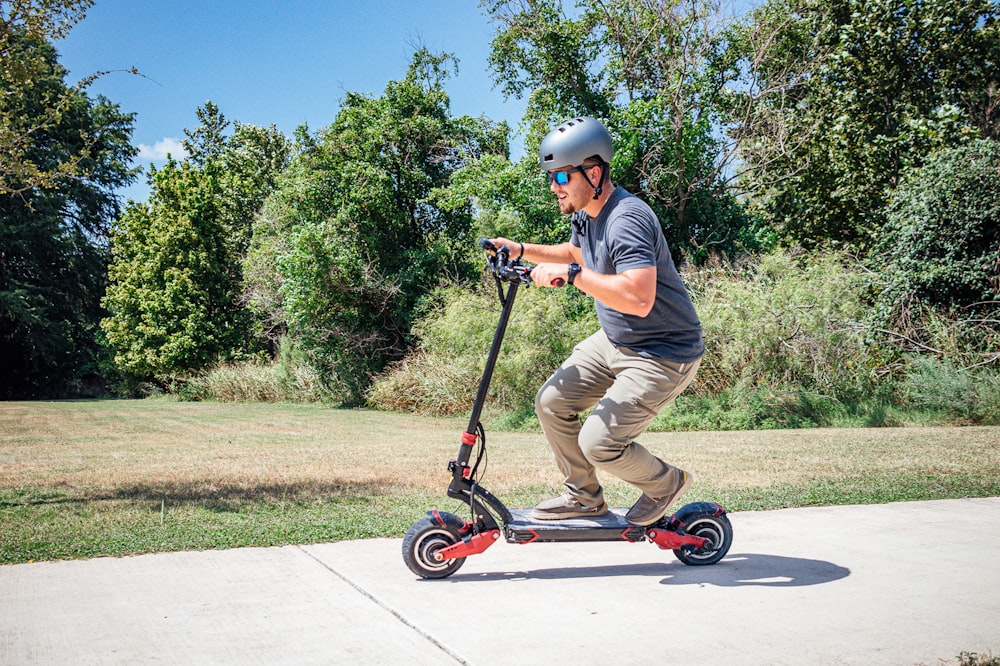a man riding a scooter on a sidewalk
