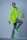 a man in a neon green jacket is dancing