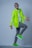a man in a neon green jacket is dancing