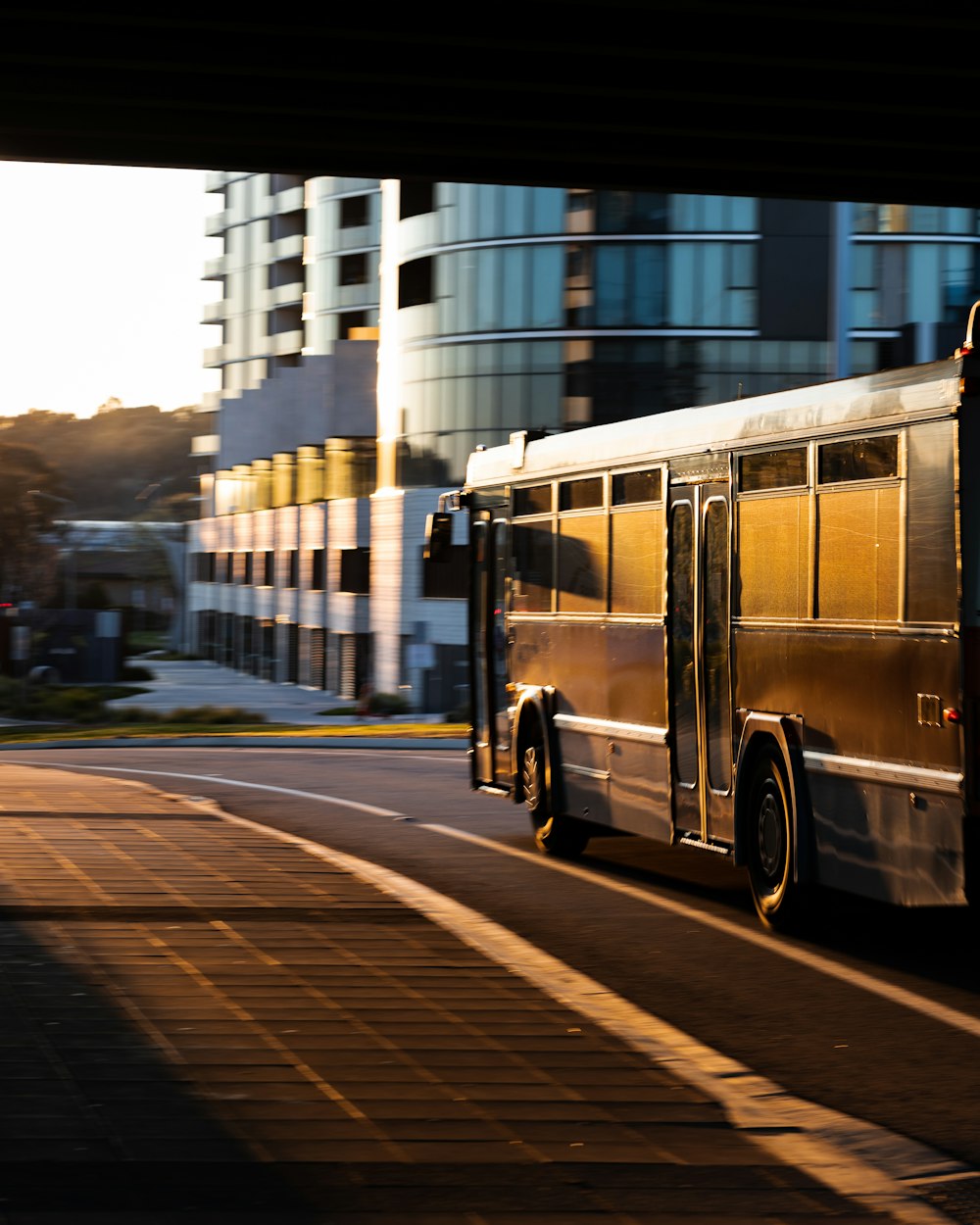 a bus driving down a street next to tall buildings