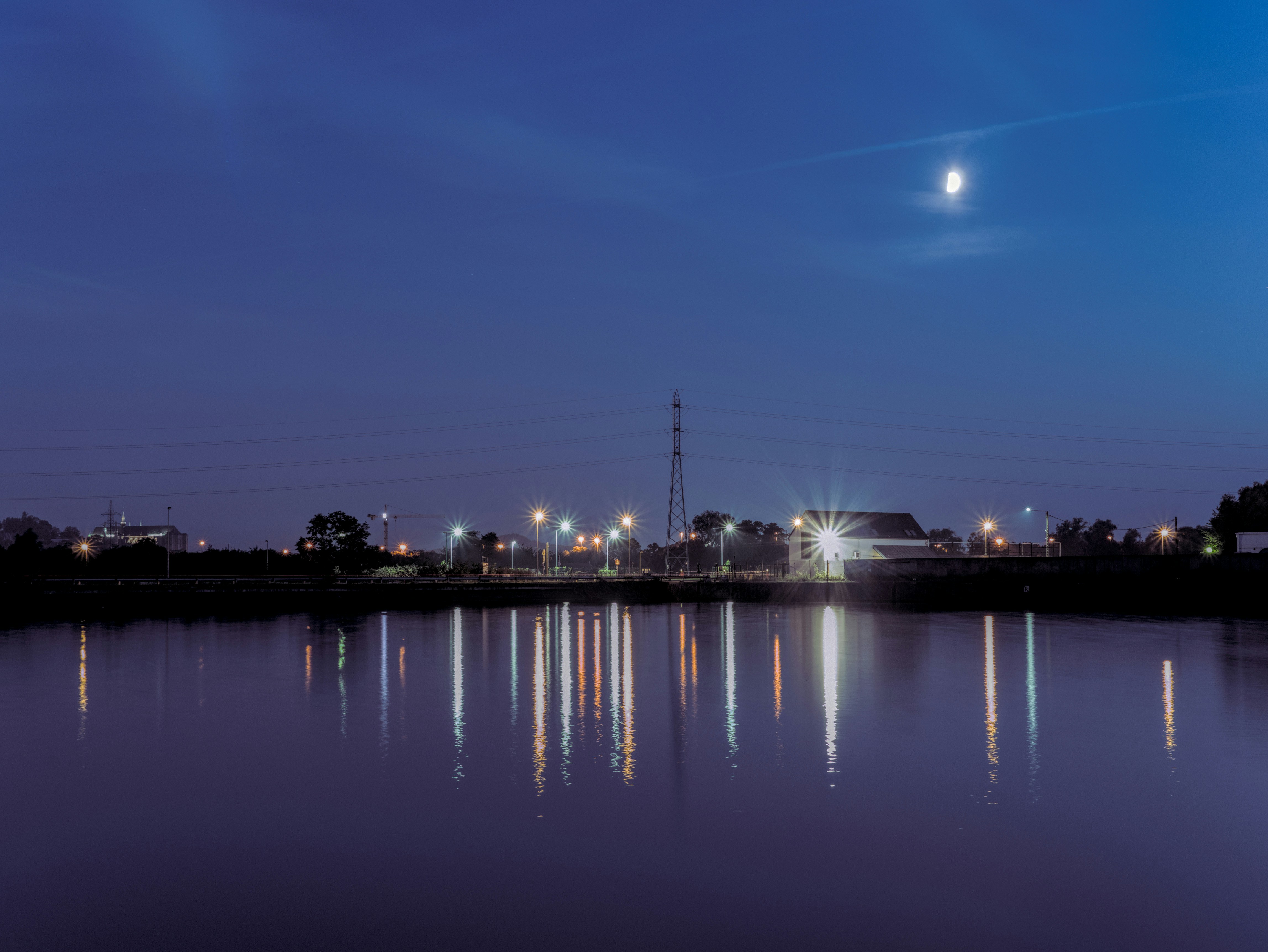Calm dark blue water reflecting moonlight at night