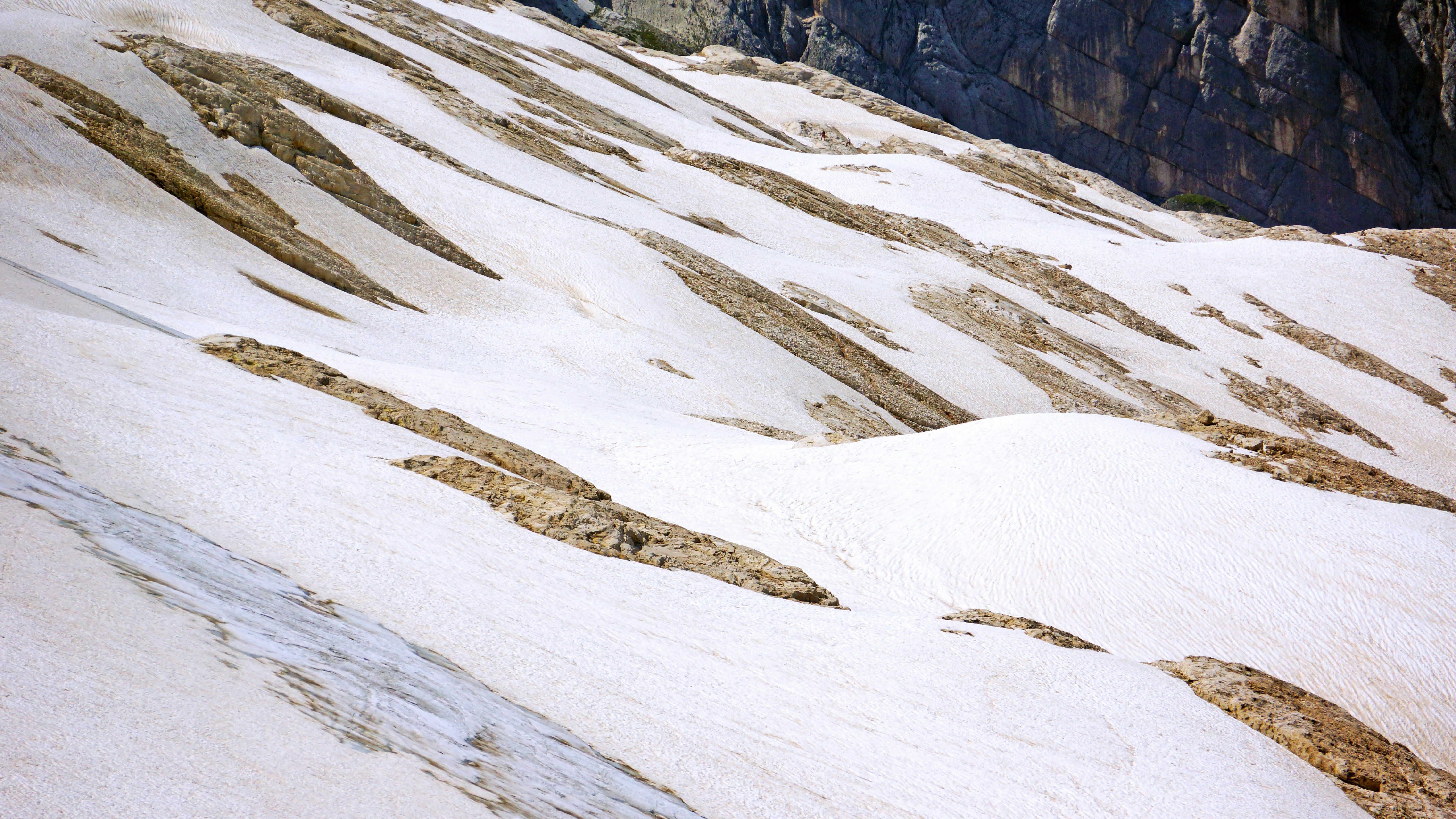 a man riding skis down a snow covered slope
