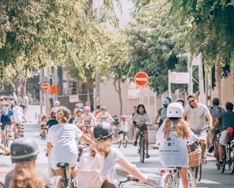 a group of people riding bikes down a street