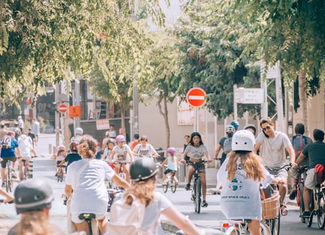 a group of people riding bikes down a street