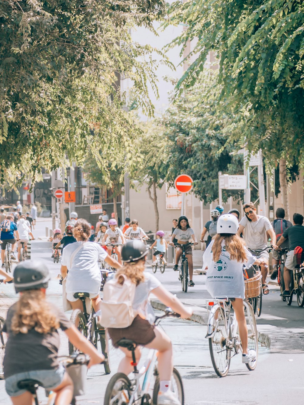 a group of people riding bikes down a street