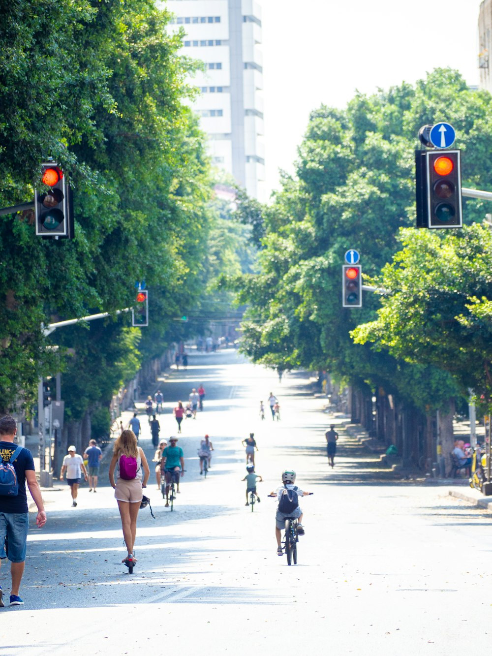 a group of people riding bikes down a street