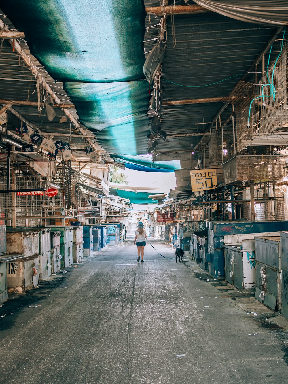 a person walking down a long narrow street