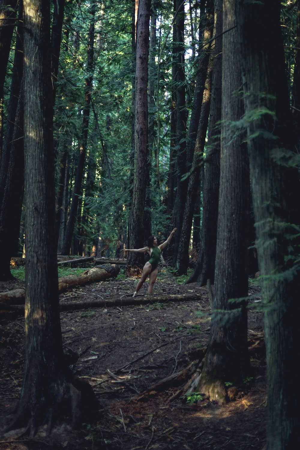a person jumping in the air in a forest