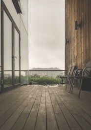 A sleek wooden rooftop deck with modern seating and ambient lighting at dusk.