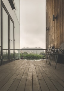 A sleek wooden rooftop deck with modern seating and ambient lighting at dusk.