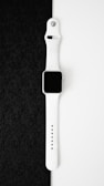 an apple watch sitting on top of a black cloth