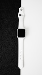 an apple watch sitting on top of a black cloth