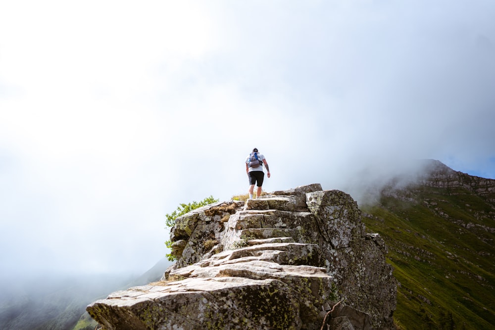 a man doing a trick on a rocky hill