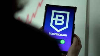 a person holding a cell phone with a blockchain logo on it