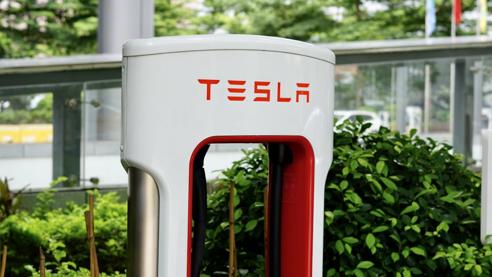 Un primer plano de una estación de carga Tesla roja y blanca