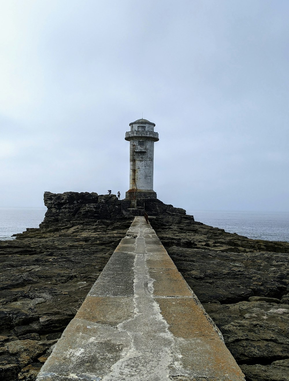 a light house sitting on top of a rocky cliff