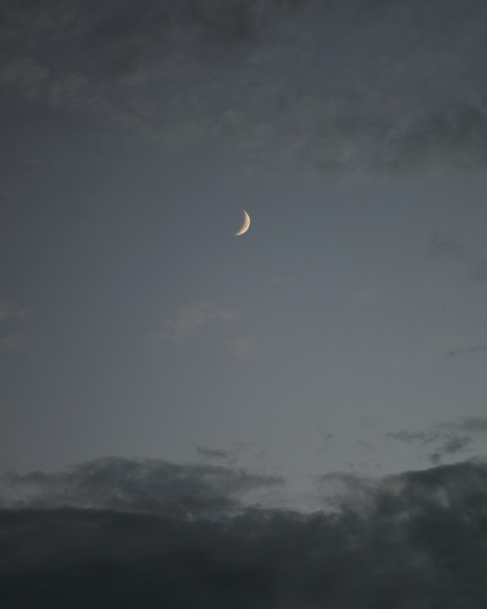 a half moon is seen in the sky