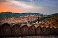 a man standing on top of a stone wall
