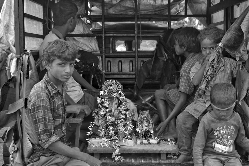 a black and white photo of a group of kids playing a game of chess