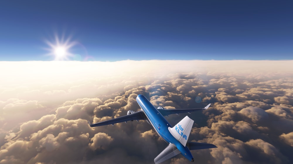 a blue and white jet flying through a cloudy sky