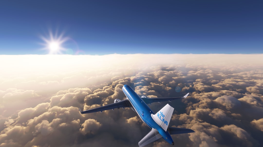 a blue and white jet flying through a cloudy sky, 