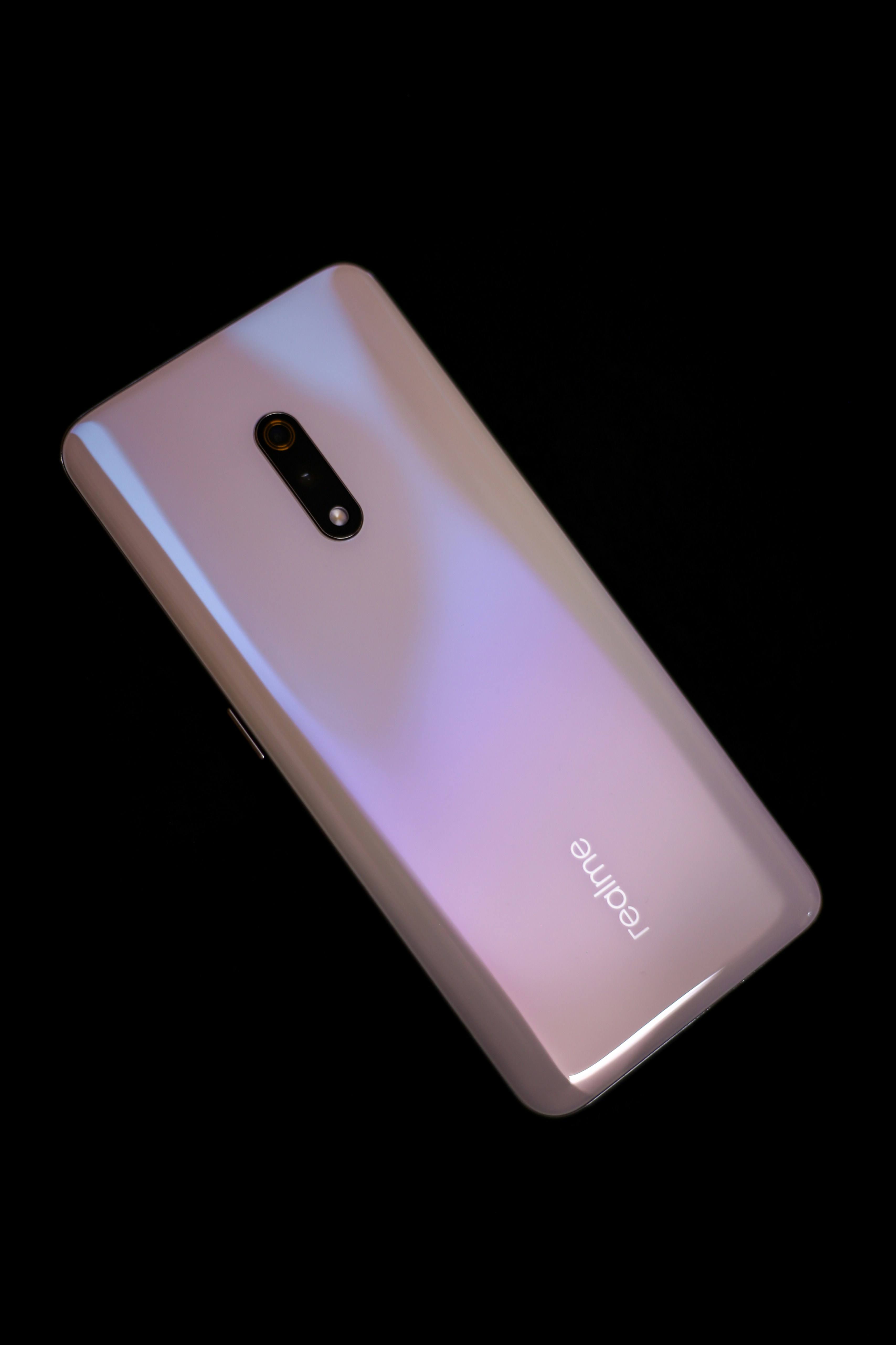 A close up of a cell phone on a black background