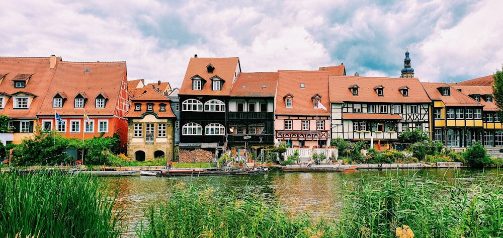 a row of buildings next to a body of water