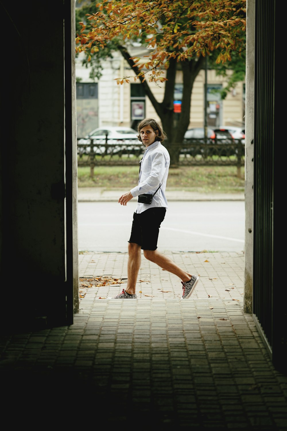 a man is walking out of a doorway