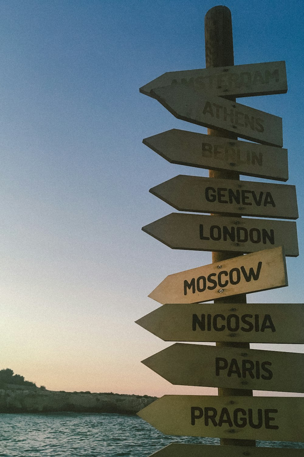 a bunch of signs that are on top of a pole