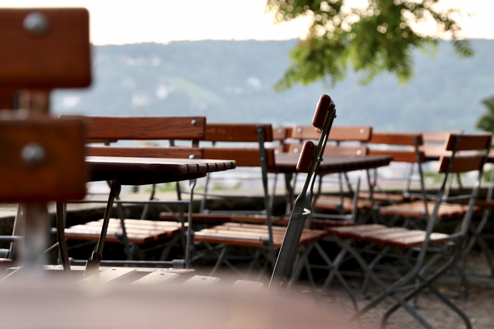 a row of wooden chairs sitting next to each other