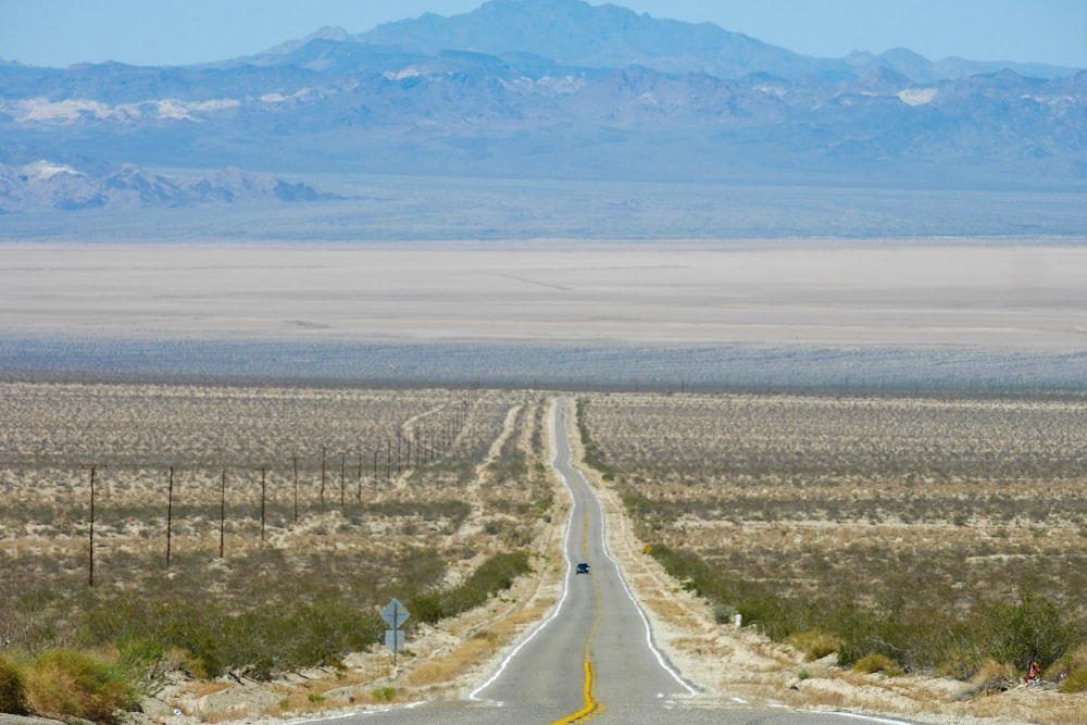 an empty road in the middle of the desert