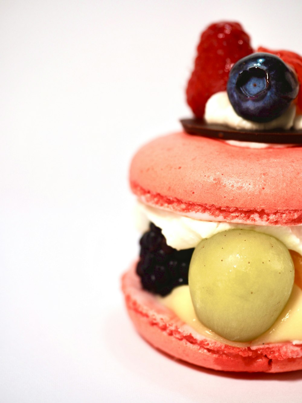 a pastry with fruit on top of it on a white surface